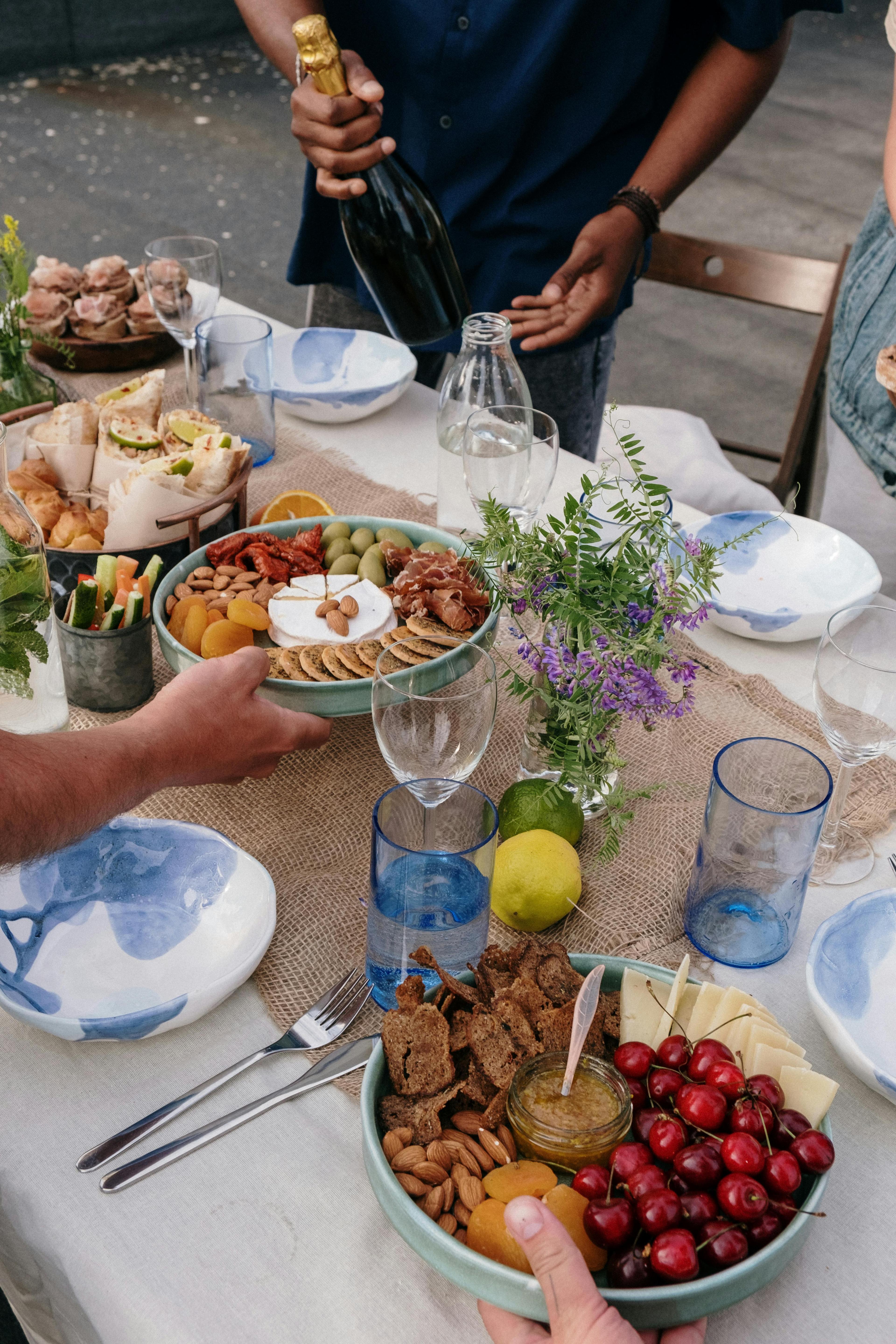 Hands serving food at a family-style table